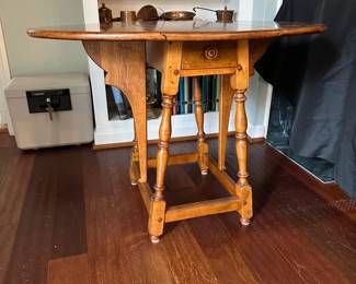 C80 - $60. Wooden Side Table with single drawer from Boston, MA. Measures 25" wide (without leaves up) 35.5" (with leaves up) 24.5" tall.