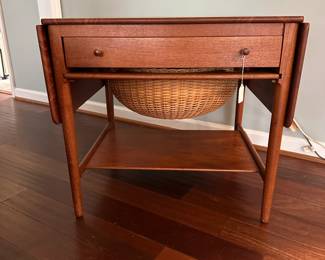 C88 - $850. 1950's Sewing Table AT-33 Hans Wegnar (by Anders Tuck) Minor imperfection noted in the picture. Measures 25.5" wide x 22.5" deep x 24" tall. Two Drop leaves are each 10.75" wide.