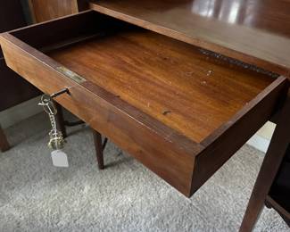 C42 - $250. Vanity & Mirror with sticker saying "Roskilde". (Probably made in Roskilde, Denmark.) Each side has a top that lifts up for jewelry storage. One door is open storage - one is drawers. Measures 50.25" wide x 20.5" deep x 33" tall. Mirror measures 37.5" tall and just screws onto the back. Decorative piece, between the legs, on the bottom right is missing. Less noticeable if its near a piece of furniture / bed.