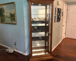 C18 - $150. Pulaski Curio / Display Cabinet. Lighted. Adjustable glass shelves. Doors open on both sides for access. Measures 34.25" wide x 15" deep x 80.5" tall.