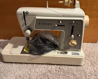 C60 - $250. Singer Sewing Machine and Folding Sewing Table. Machine serial number AS215287 in great condition. Table is also in great condition, measures 32" Wide x 32" Deep x 28.5" Tall. Has cutout for machine to fit into.