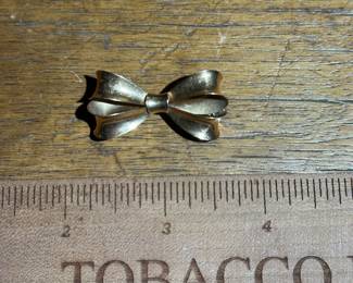 D11 - $220. 14kt gold bow brooch