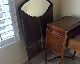 C42 - $250. Vanity & Mirror with sticker saying "Roskilde". (Probably made in Roskilde, Denmark.) Each side has a top that lifts up for jewelry storage. One door is open storage - one is drawers. Measures 50.25" wide x 20.5" deep x 33" tall. Mirror measures 37.5" tall and just screws onto the back. Decorative piece, between the legs, on the bottom right is missing. Less noticeable if its near a piece of furniture / bed.