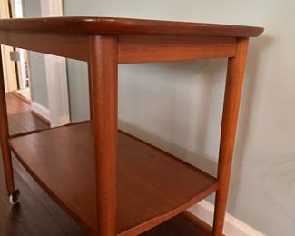 C90 - $250. MCM Wheeled Side Table. Measures 28.5" wide x 18" deep x 25" tall.