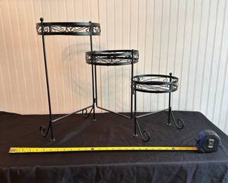 C6 - $20. Metal Plant Stand. Adjustable. Measures 10.5" - 28" Wide x 18.5" Tall.