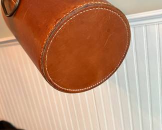 C10 - $350. Carl Aubock Leather Waste Basket with metal loop handle. Measures 11.5" Tall x 9.75" Wide.