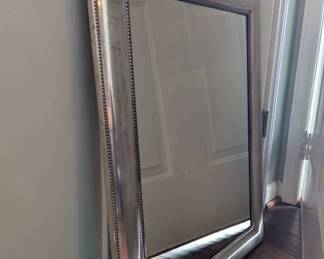 C107 - $30. Silver Framed Heavy Wall Mirror. (Can be hung vertically or horizontally.) Measures 22.5" wide x 29.5" tall.
