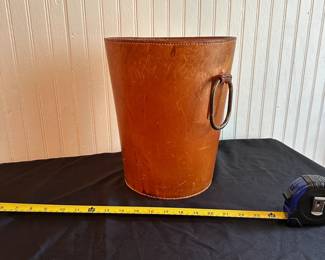 C10 - $350. Carl Aubock Leather Waste Basket with metal loop handle. Measures 11.5" Tall x 9.75" Wide.