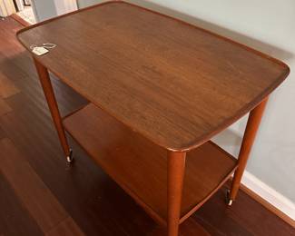 C90 - $250. MCM Wheeled Side Table. Measures 28.5" wide x 18" deep x 25" tall.