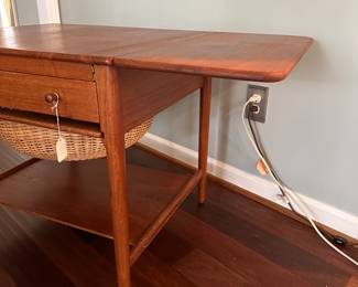 C88 - $850. 1950's Sewing Table AT-33 Hans Wegnar (by Anders Tuck) Minor imperfection noted in the picture. Measures 25.5" wide x 22.5" deep x 24" tall. Two Drop leaves are each 10.75" wide.