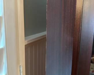 C15 - Small amount of damage on one side. $250. Small Corner Curio With Key. Tag reads 1966 on the back. Measures 25" wide x 15" deep x 75" tall.