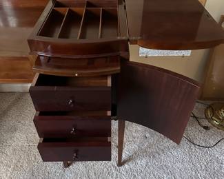 C42 - $250. Vanity & Mirror with sticker saying "Roskilde". (Probably made in Roskilde, Denmark.) Each side has a top that lifts up for jewelry storage. One door is open storage - one is drawers. Measures 50.25" wide x 20.5" deep x 33" tall. Mirror measures 37.5" tall and just screws onto the back. Decorative piece, between the legs, on the bottom right is missing. Less noticeable if its near a piece of furniture / bed.