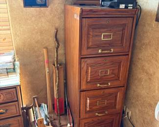 file cabinet, magazine rack, walking sticks, clock, belt buckles