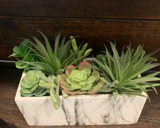 Artificial succulents in a marble pot