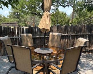 Patio set of large round glass table, umbrella and 6 chairs