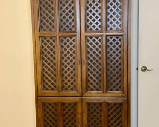 Vtg. two-door wooden armoire with intricate lattice work