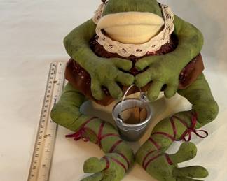 Lots of decorative stuffed frogs