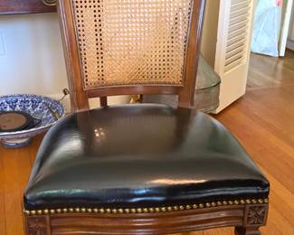 Set of eight hobnailed leather dining chairs with caned backs. Two arm and six  side.