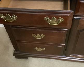 Drawers in dark cherry dresser.