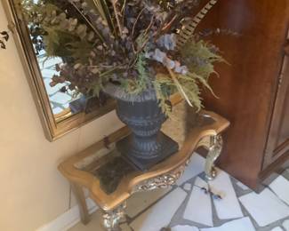 Tall gold mirror with small table.