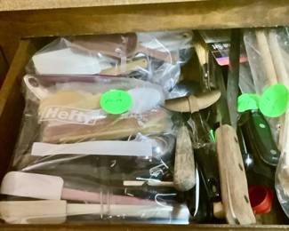 Drawer full of knives and other utensils.