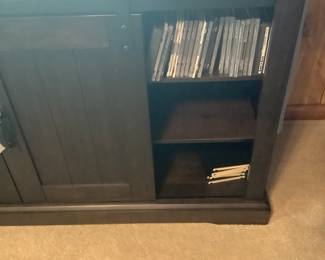 Black cabinet with barn doors. Measures: 60” long, 15 3/4” depth, 31 1/2” tall. Price: 165.00
