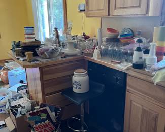 bar stool, cookie crock, glasses, dishes, tupperware