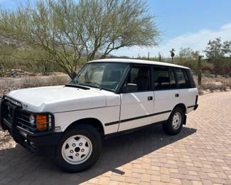 A vintage 1993 LWB Range Rover, 140k miles, AWD gearbox replaced, sunroof, leather, new exhaust, new shocks, custom wheels, and new tires for ten grand.
