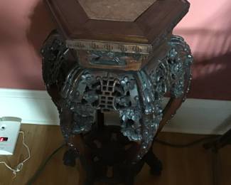 Carved wooden plant stand with marble top