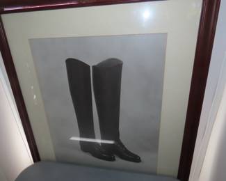 Framed riding boots and saddle artwork.