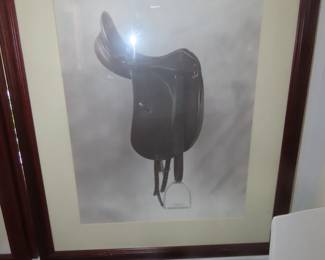 Framed riding boots and saddle artwork.