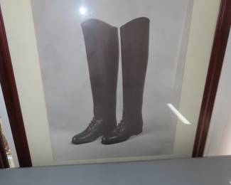 Framed riding boots and saddle artwork.