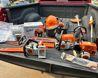 A variety of Stihl equipment: including a MS193T (USED) and a MS251 (NEVER USED) chain saws, a KM90R unit with a trimmer and extended chain saw, chain saw sharpener NEW, 2 BRAND new ProMark Helmet Systems and acouple of chain saw chains.
