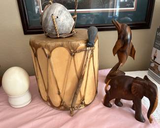 On the left - an ostrich egg, both the Native American drum and the pottery pc sitting on the drum were made in Sedona, Arizona, the dolphin was hand-carved in Jamaica and the elephant was hand-carved in Africa.
