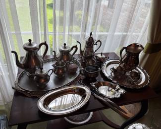 Lots of silver trays and silver plated serving trays and coffee and tea service 