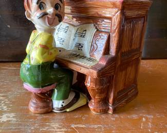 vintage ceramic clown figurine playing a piano
