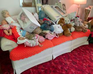 There is a couch under all the bears and dolls