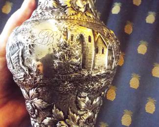 CLOSE UP OF ANTIQUE S. KIRK & SONS STERLING REPOUSSE LEAFY BERRY PITCHER