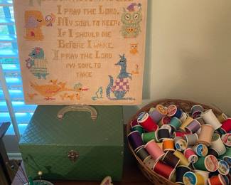 Basket of thread , embroidery piece, pin cushions