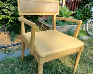 Set of 2 blonde MCM chairs with cane back and yellow, brocade-like, patterned seat.