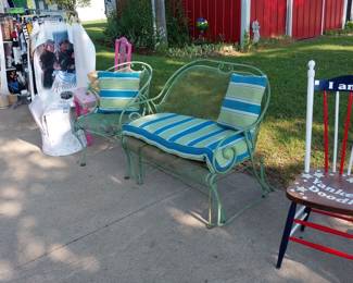 wrought iron bench, chair, posters