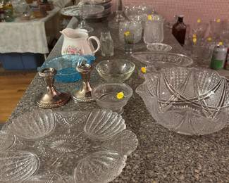Numerous pieces of pressed glass.