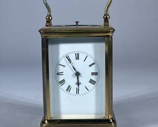 ANTIQUE FRENCH BRASS TABLE CARRIAGE CLOCK | Marked “Made in France” with additional markings. Glass door opens in back. A small knob on top when pushed sounded bells. - h. 7 x w. 4 x d. 3.5 in (to top of handle.)