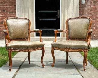(2pc) PAIR UPHOLSTERED FRENCH LOUIS XV CARVED WALNUT ARMCHAIRS | Carved Louis XV style armchairs on walnut frames with cabriole legs. Leather upholstery with brass nail head detailing.
Seat height 16 in - h. 33 x w. 23.75 x d. 19.5 in