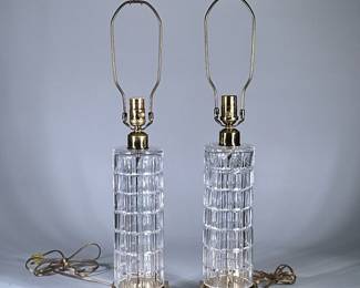 (2pc) PAIR WATERFORD CUT CRYSTAL CYLINDER LAMPS | Cut crystal cylinder lamps with brass bases and finials. Original lampshades included. - h. 28 x w. 6 x l. 6 in (to top of finial,