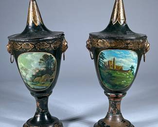 PAIR TOLE PAINTED CHESNUT URNS | Antique metal chestnut urns with tops and hand-painted countryside scenes. Lion head rings on sides.
Dimensions: h. 13 x dia. 5 in (to top of top.)