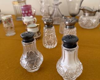 cut glass, sterling salt and pepper shakers, sterling topped pitchers, cut glass vinegar holder, cranberry glass cup