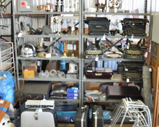 Rack with antique and vintage typewriters and decor items.  The are a number of Hagerty Silversmith products for keeping your silver bright and pretty.  Interesting vintage pieces include a Bell and Howell Portable Editing mechanism and a Rollei slide projector that works with 4x4 inch slides.