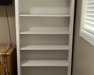Tall sturdy white self standing wooden shelves with white backboard