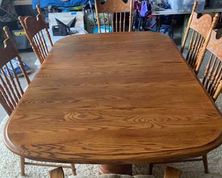 PRESALE Item: Beautiful Oak table. Leaves under the top, 6 chairs can seat up to 12.